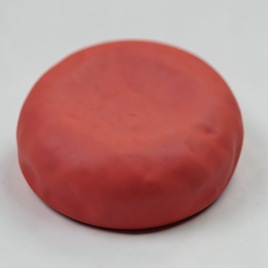 A clay-model abstract composition of rounded forms in deep navy and warm coral, evoking strength and togetherness.